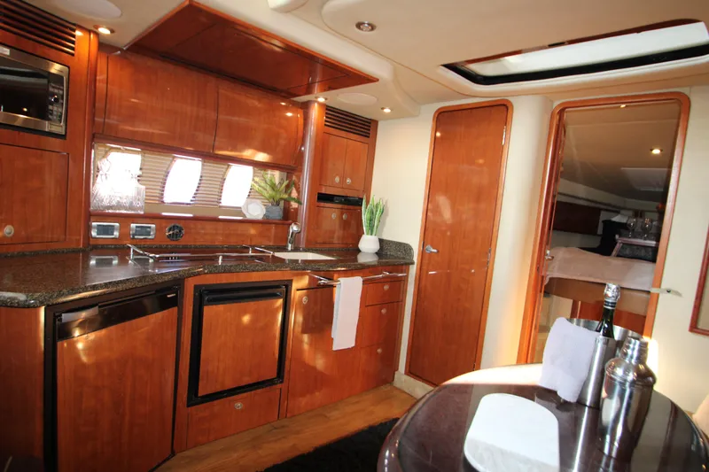 Slide: The Image of Luxurious 2006 Sea Ray 400 Sundancer yacht interior with modern kitchen amenities. - 10
