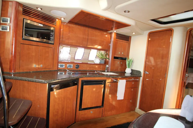 Slide: The Image of Luxurious 2006 Sea Ray 400 Sundancer interior with leather seating and elegant wood finishes. - 12