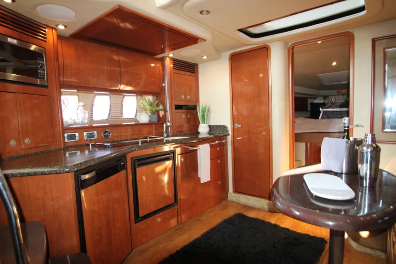 Slide: The Image of Luxurious 2006 Sea Ray 400 Sundancer yacht interior with modern kitchen and cozy cabin. - 13