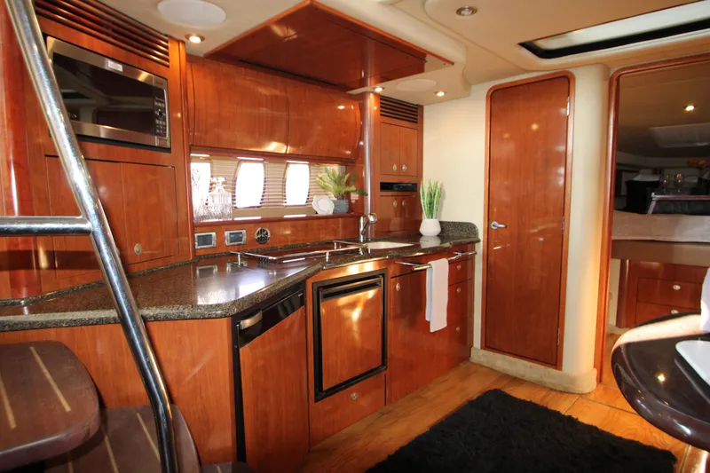 Slide: The Image of Luxurious interior of 2006 Sea Ray 400 Sundancer yacht with modern kitchen amenities. - 14