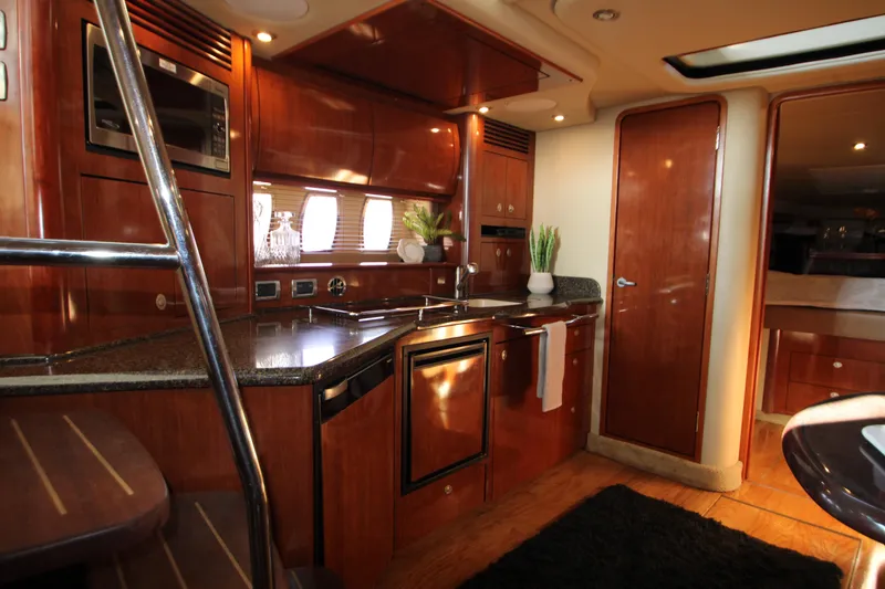 Slide: The Image of Luxurious 2006 Sea Ray 400 Sundancer yacht interior with modern kitchen amenities. - 15