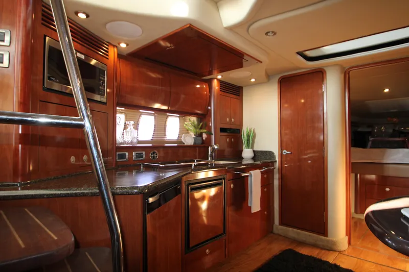 Slide: The Image of Luxurious interior of 2006 Sea Ray 400 Sundancer yacht with modern kitchen amenities. - 16