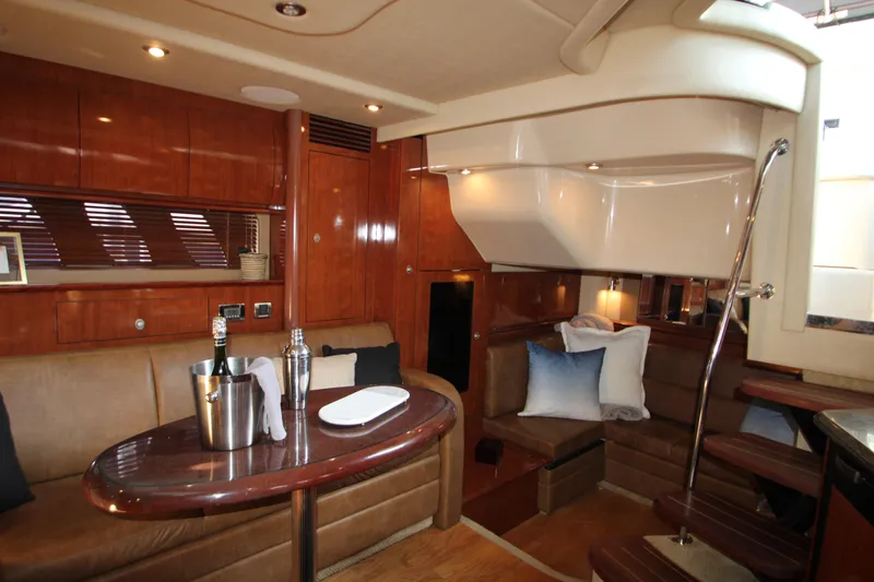 Slide: The Image of Luxurious 2006 Sea Ray 400 Sundancer yacht interior with sleek kitchen and wooden cabinetry. - 19