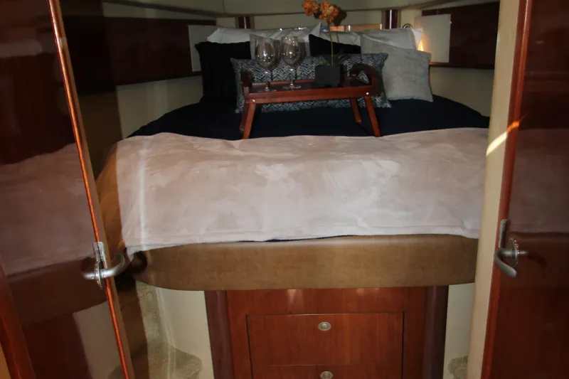 Slide: The Image of Luxurious 2006 Sea Ray 400 Sundancer yacht interior with elegant wood finishes and cozy seating. - 22