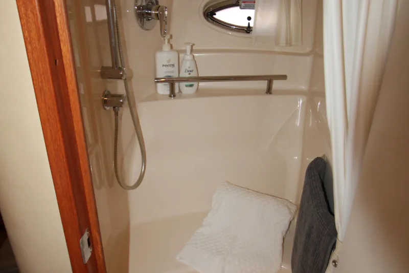 Slide: The Image of Luxurious interior of 2006 Sea Ray 400 Sundancer with TV, flower, and wine glass. - 27