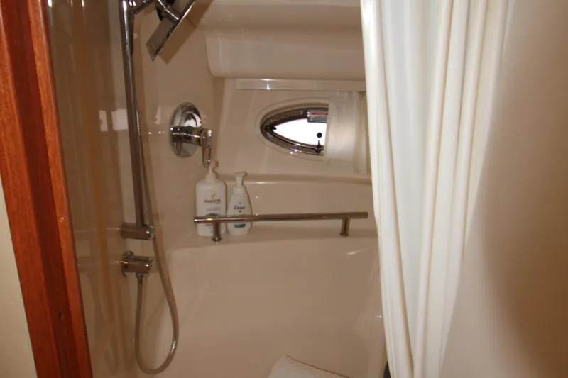 Slide: The Image of 2006 Sea Ray 400 Sundancer bathroom with sink, toilet, and porthole window. - 28