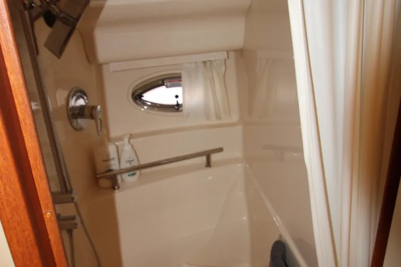 Slide: The Image of Bathroom interior of 2006 Sea Ray 400 Sundancer yacht with sink and porthole. - 29