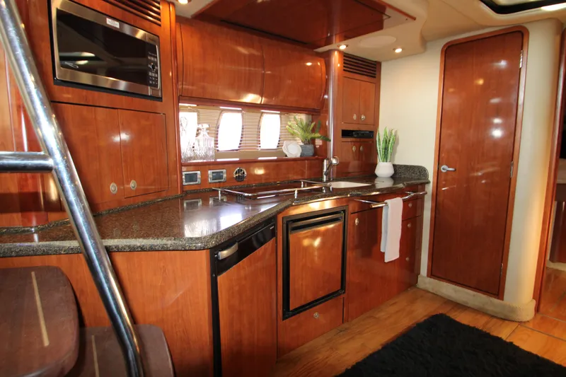 Slide: The Image of Luxurious interior of 2006 Sea Ray 400 Sundancer yacht with leather seating and wooden finishes. - 37