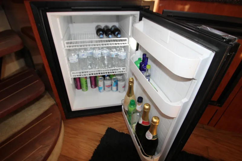 Slide: The Image of Luxurious 2006 Sea Ray 400 Sundancer yacht kitchen with wood cabinetry and modern appliances. - 39