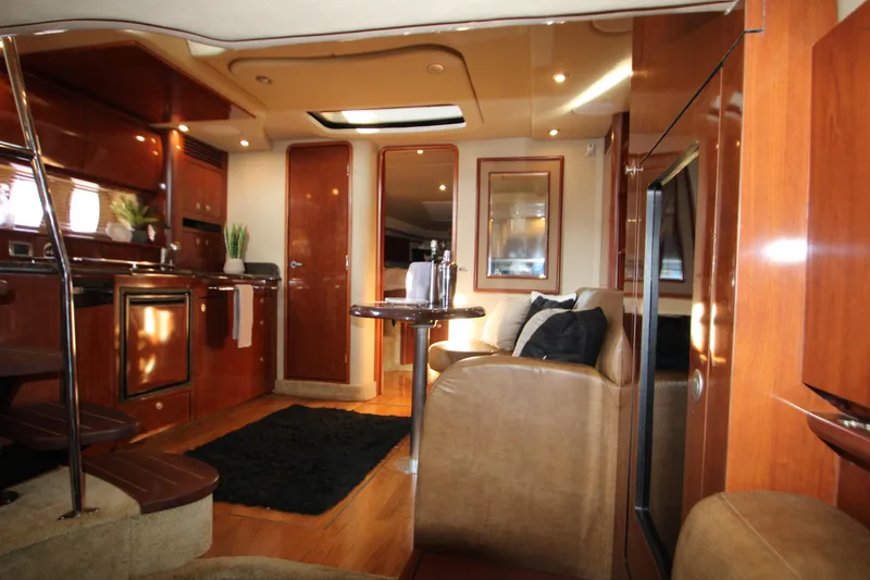Slide: The Image of Interior of 2006 Sea Ray 400 Sundancer with leather seating and wall-mounted TV. - 45