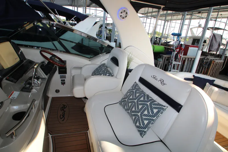 Slide: The Image of Helm of 2006 Sea Ray 400 Sundancer with wooden steering wheel and navigation controls. - 50