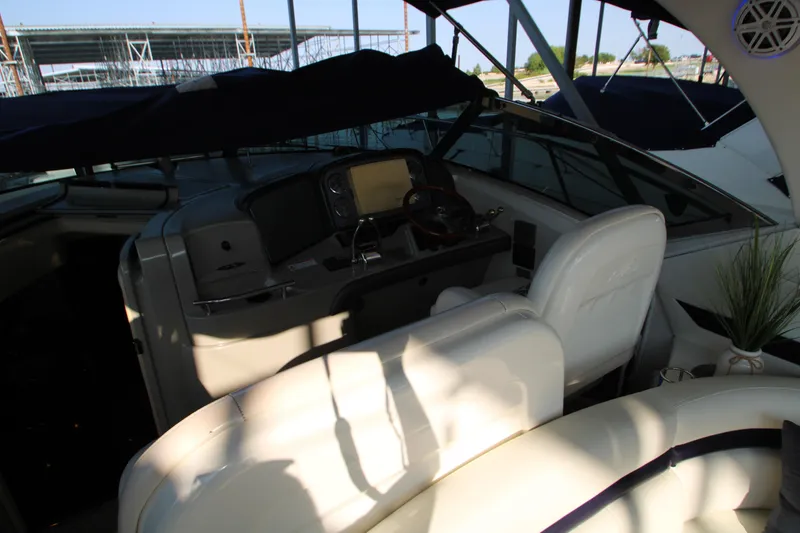 Slide: The Image of 2006 Sea Ray 400 Sundancer interior with speakers and canopy, docked at marina. - 57