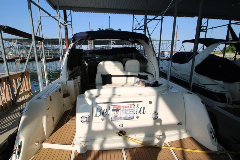 Slide: The Image of Chrome bell and speaker on 2006 Sea Ray 400 Sundancer yacht, docked by the water. - 64