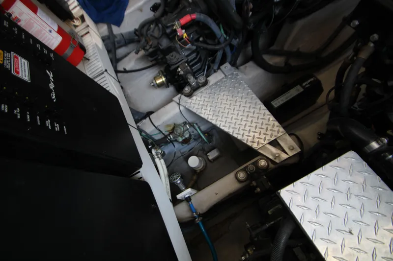 Slide: The Image of Engine compartment of a 2006 Sea Ray 400 Sundancer with visible batteries and wiring. - 66