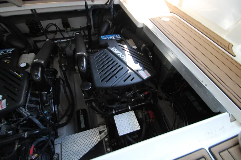 Slide: The Image of Engine compartment of a 2006 Sea Ray 400 Sundancer with metal plating and wiring. - 67