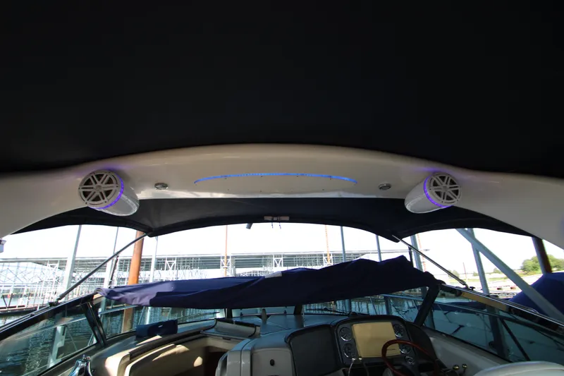 Slide: The Image of 2006 Sea Ray 400 Sundancer yacht docked at marina, featuring spacious deck area. - 77