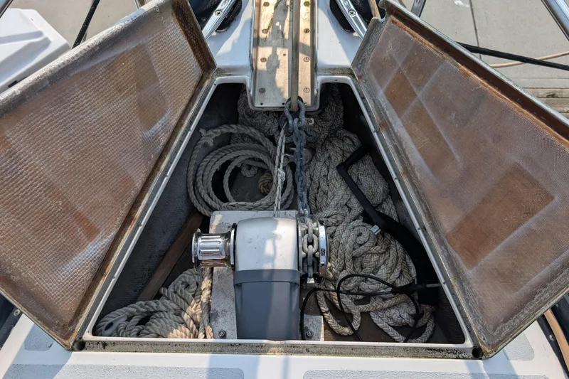 Slide: The Image of Anchor locker of 1987 Cascade Center Cockpit sailboat with ropes and chains. - 11