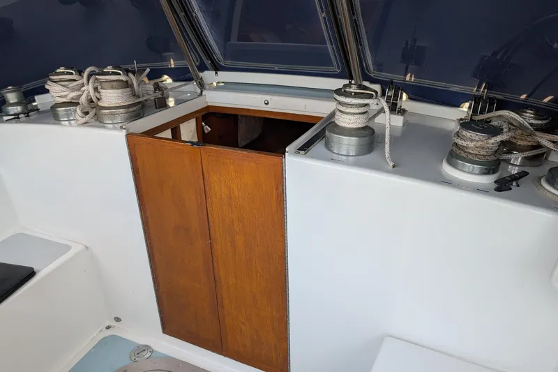 Slide: The Image of 1987 Cascade Center Cockpit sailboat with winches and ropes, featuring a wooden hatch. - 12