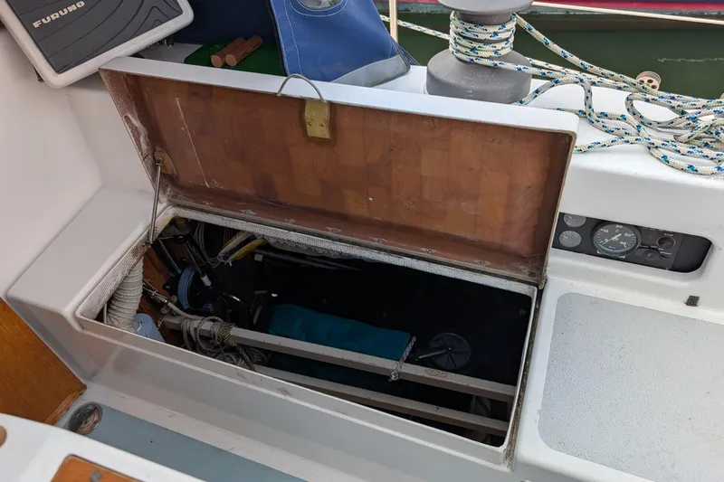 Slide: The Image of Open hatch on 1987 Cascade Center Cockpit sailboat, revealing interior storage and equipment. - 17
