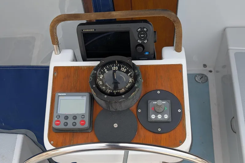 Slide: The Image of Cockpit controls of a 1987 Cascade Center Cockpit sailboat with compass and navigation instruments. - 19