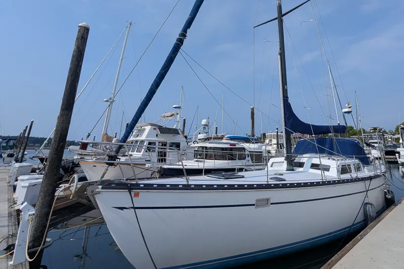Slide: The Image of 1987 Cascade Center Cockpit sailboat docked at a marina under a clear blue sky. - 3