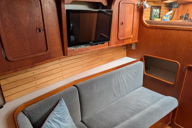Slide: The Image of 1987 Cascade Center Cockpit interior with wooden cabinetry, TV, and cushioned seating. - 34