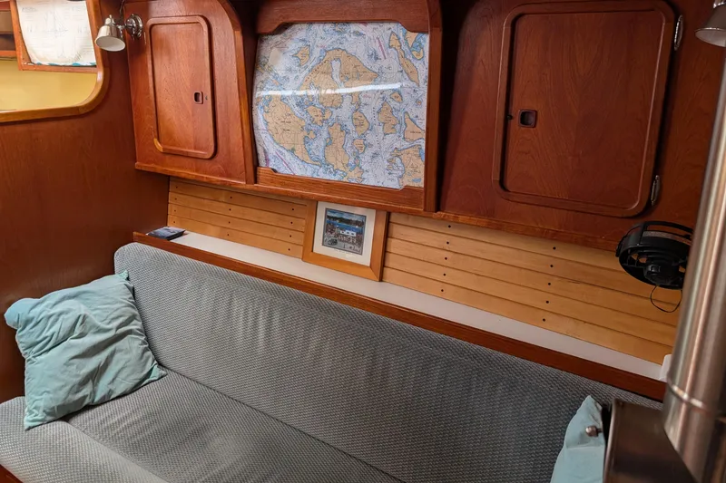 Slide: The Image of Cozy interior of 1987 Cascade Center Cockpit sailboat with map and wooden cabinets. - 36