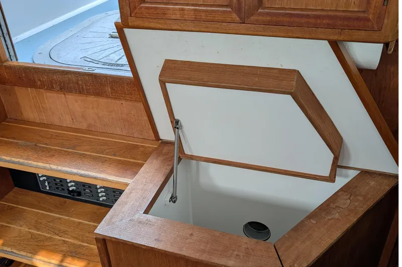 Slide: The Image of 1987 Cascade Center Cockpit interior with wooden cabinetry and open storage compartment. - 46