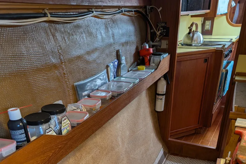 Slide: The Image of 1987 Cascade Center Cockpit interior with organized storage and kitchen area. - 47