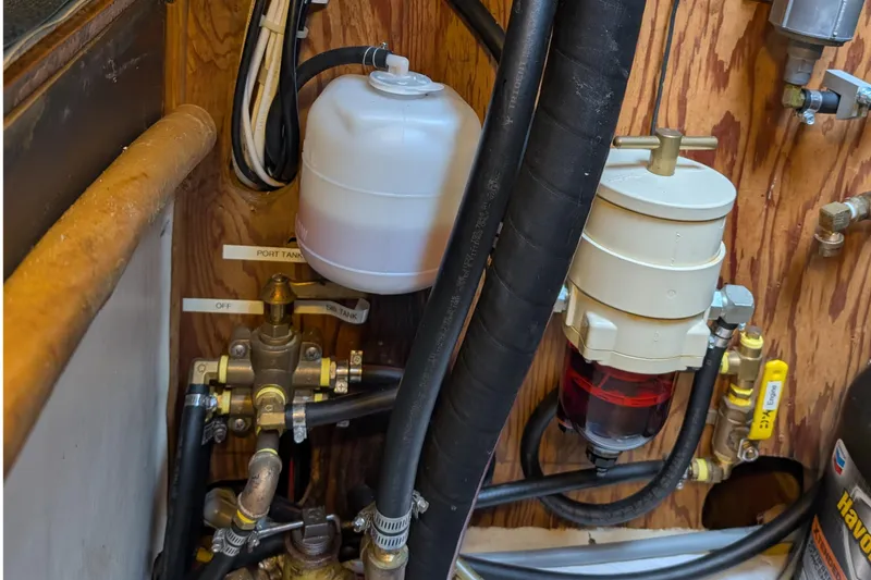 Slide: The Image of Engine compartment of 1987 Cascade Center Cockpit with fuel system components and hoses. - 48