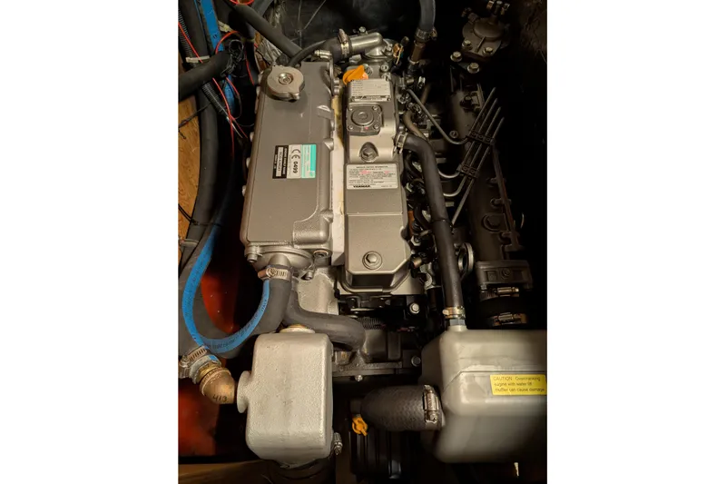 Slide: The Image of Engine of 1987 Cascade Center Cockpit sailboat, featuring hoses and mechanical components. - 50