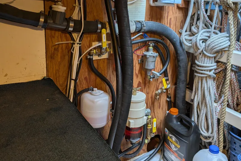 Slide: The Image of Engine room of a 1987 Cascade Center Cockpit sailboat with ropes and mechanical components. - 51