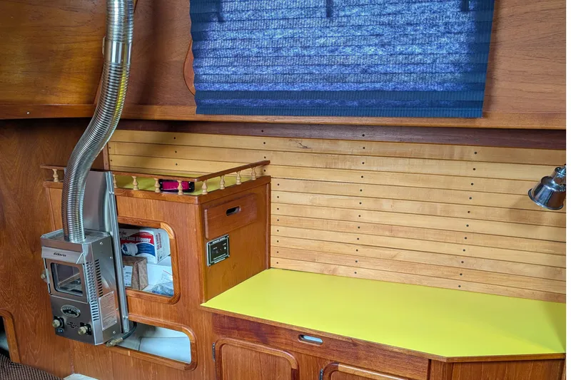 Slide: The Image of 1987 Cascade Center Cockpit interior with wood paneling, heater, and yellow countertop. - 52