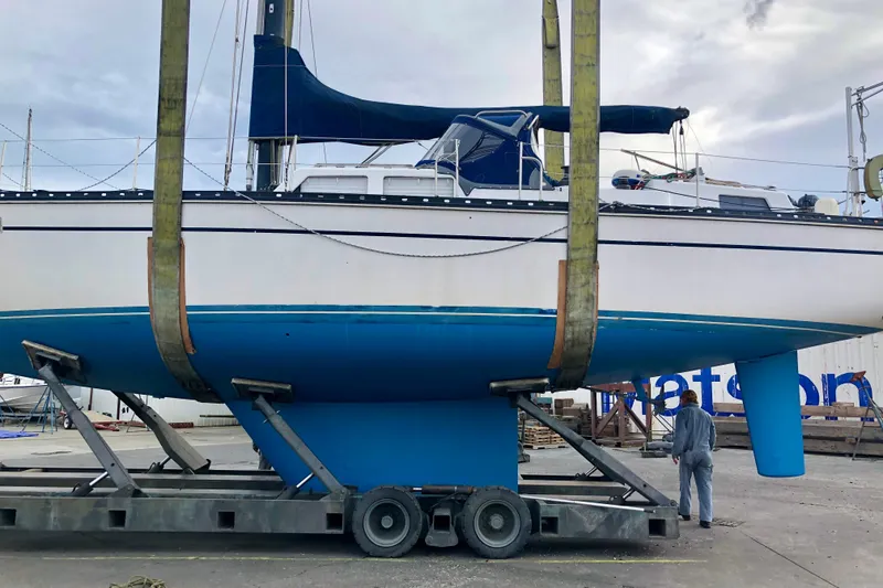 Slide: The Image of 1987 Cascade Center Cockpit sailboat on trailer, undergoing maintenance at a shipyard. - 55