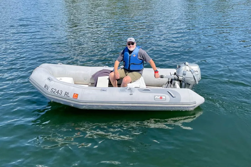 Slide: The Image of Man in inflatable boat on water, wearing blue life vest, Cascade Center Cockpit 1987. - 56