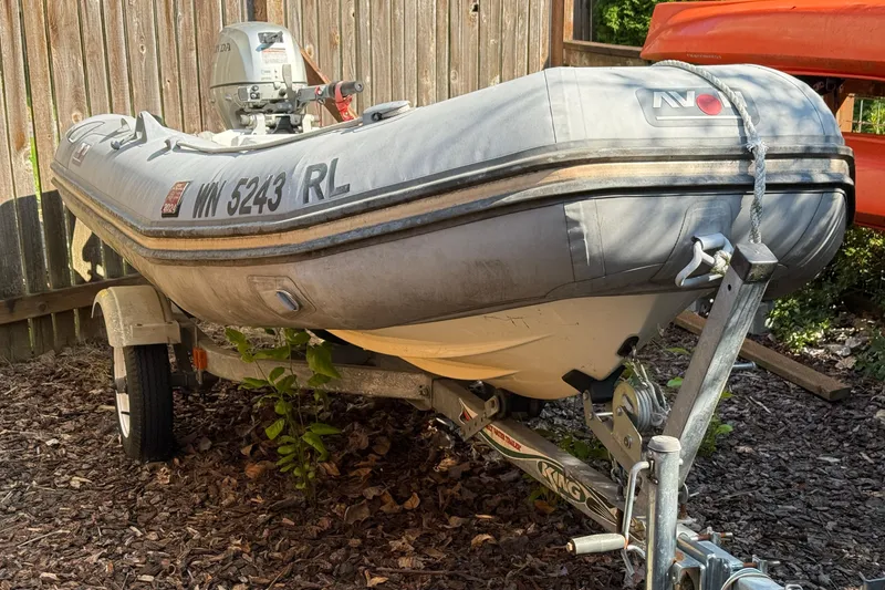 Slide: The Image of Inflatable boat on trailer with Honda motor, Cascade Center Cockpit 1987 model. - 57