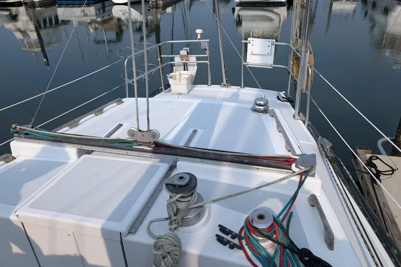 Slide: The Image of 1987 Cascade Center Cockpit sailboat deck with rigging and marina background. - 8