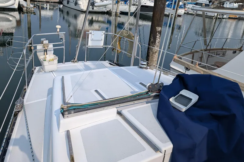 Slide: The Image of 1987 Cascade Center Cockpit sailboat deck in marina, featuring clean lines and nautical equipment. - 9