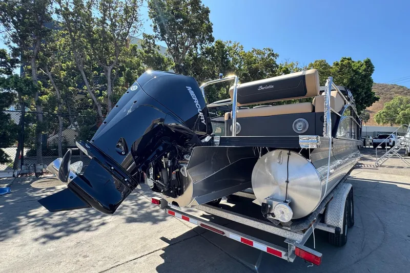 Slide: The Image of 2026 Barletta Cabrio 24UE pontoon boat on trailer, parked outdoors. - 14
