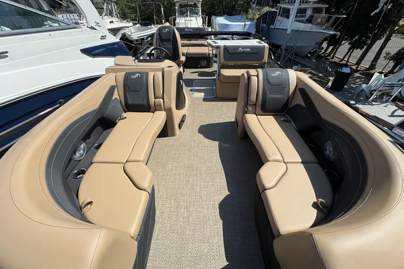 Slide: The Image of 2026 Barletta Cabrio 24UE pontoon boat with canopy, docked outdoors. - 18