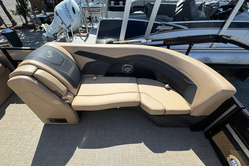 Slide: The Image of 2026 Barletta Cabrio 24UE pontoon boat with canopy, parked outdoors. - 19