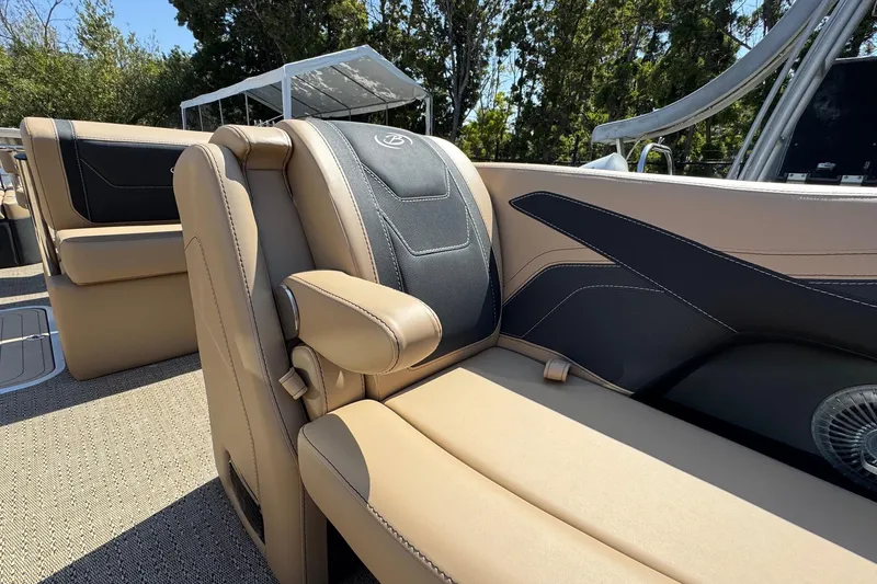 Slide: The Image of 2026 Barletta Cabrio 24UE pontoon boat on trailer, parked outdoors under clear blue sky. - 20