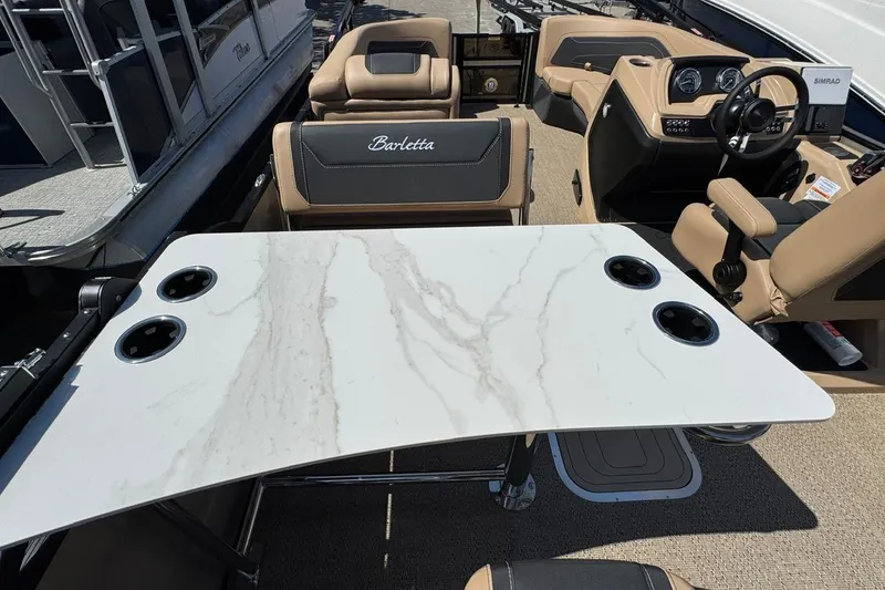 Slide: The Image of 2026 Barletta Cabrio 24UE pontoon boat on trailer, parked outdoors. - 33