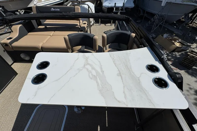 Slide: The Image of 2026 Barletta Cabrio 24UE pontoon boat with canopy, parked outdoors. - 34
