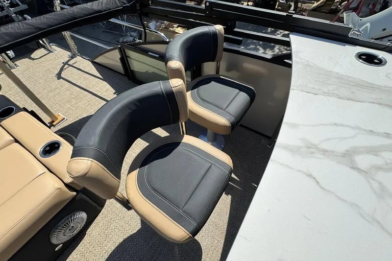 Slide: The Image of 2026 Barletta Cabrio 24UE boat interior with luxurious tan and black seating. - 38