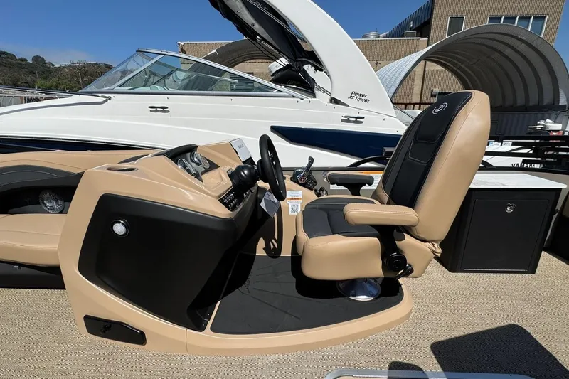 Slide: The Image of 2026 Barletta Cabrio 24UE boat interior with tan seating and storage compartment. - 42