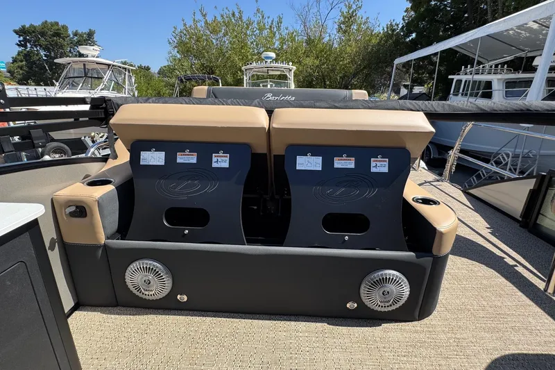 Slide: The Image of Luxurious seating area on 2026 Barletta Cabrio 24UE pontoon boat with table and cup holders. - 58