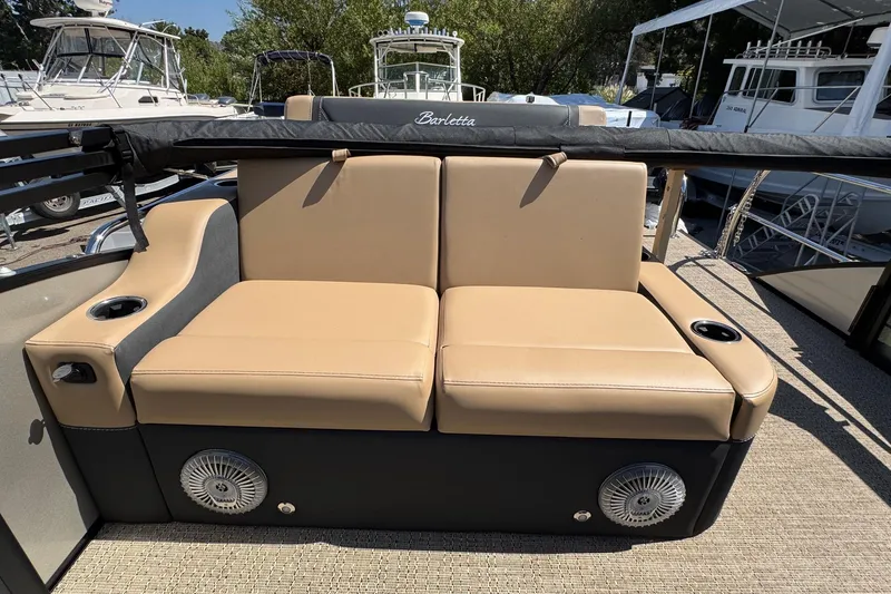 Slide: The Image of Luxurious seating area on 2026 Barletta Cabrio 24UE pontoon boat with beige upholstery. - 59