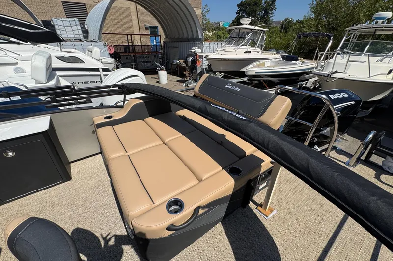 Slide: The Image of 2026 Barletta Cabrio 24UE pontoon boat interior with beige seating and carpet flooring. - 61