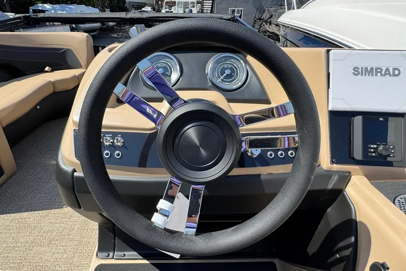 Slide: The Image of Steering wheel and dashboard of 2026 Barletta Cabrio 24UE boat with Simrad display. - 68